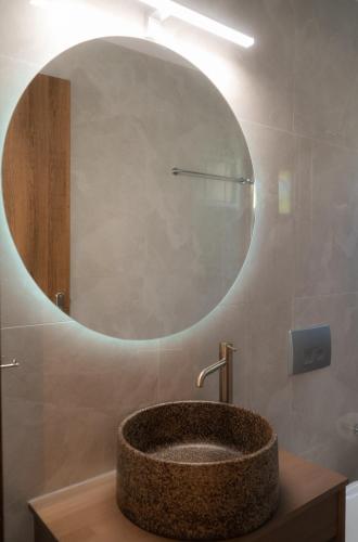 a bathroom with a sink with a large mirror at Villa Trigona in Kalabaka
