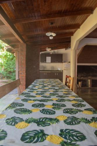 a large room with a large table with a blanket on it at Hotel Tierra Colorada in Puerto Iguazú