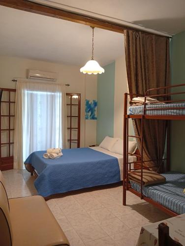a bedroom with two bunk beds and a couch at Irida maria Family studios in Agios Ioannis Pelio