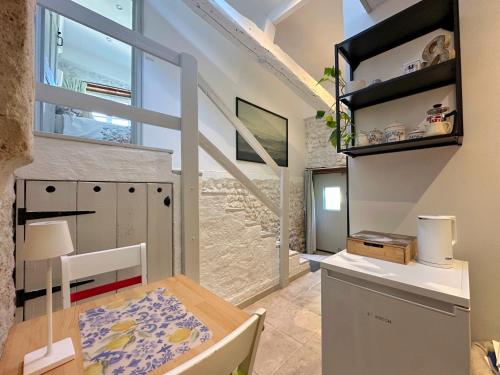 a small kitchen with a table and a window at Entire apartment with swimming pool near Aubeterre in Saint-Romain
