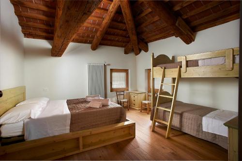 ein Schlafzimmer mit zwei Etagenbetten und einer Leiter in der Unterkunft Rum Oliero in Valbrenta 