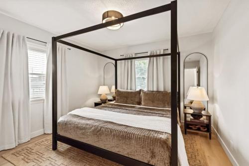 a bedroom with a canopy bed with a large mirror at The Luxury Haus in Grove City