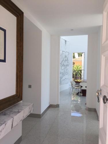 a hallway with a door and a table and chairs at Villa Mirano in Éze