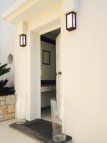 a hallway with two glass vases on the floor at Villa Mirano in Éze