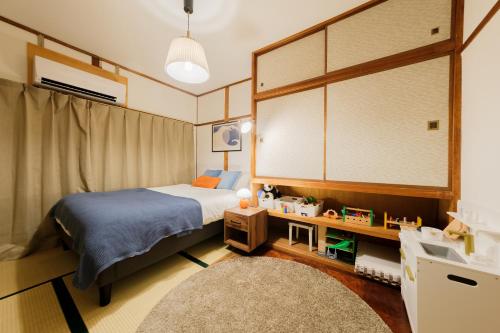 a bedroom with a bed and a sink in it at Castle Land NAGOYA Family Friendly 5min from Station in Nagoya