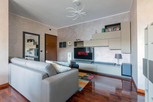 a living room with a couch and a tv at Fiera Suite Relax in Ponte Galeria