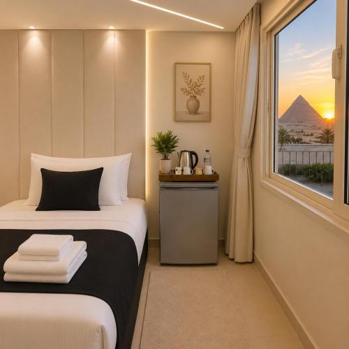 a room with a bed and a window with a pyramid at Oyal Scarab Pyramids View in Cairo