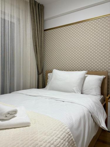 a bedroom with a large bed with white sheets at Astera 4 in Vrnjci