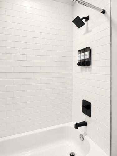 a white bathroom with a tub and a sink at Downtown Detroit Hidden Gem Walk to Venues & DMC in Detroit