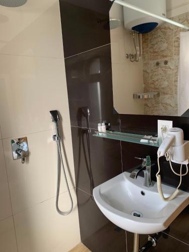 a bathroom with a sink and a mirror at SR99 Hotel in Tirana