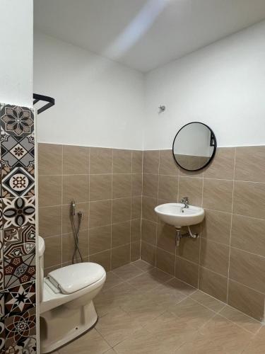 a bathroom with a toilet and a sink at Seroja Homestay Gopeng in Gopeng