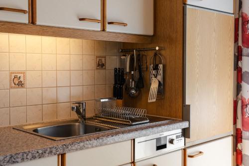 a kitchen with a sink and a counter top at Ferienhaus Enzi in Weissbriach