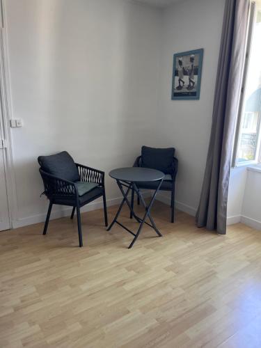 a room with two chairs and a table and a window at Ker Lucie in Crozon
