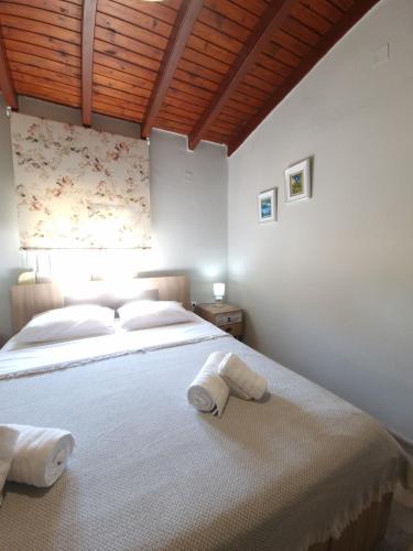 a bedroom with a large bed with towels on it at komi's family house in Kómi