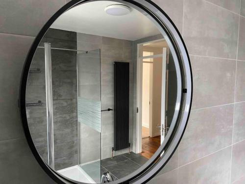 a mirror in a bathroom with a shower at Daline House Clonakilty in Clonakilty