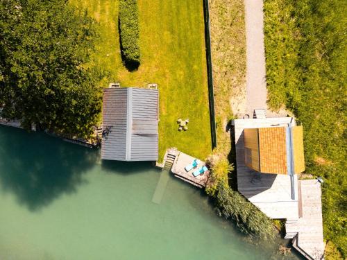 an aerial view of a building on a body of water at Haus Uschi in Klagenfurt