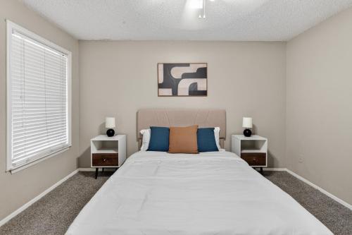 a bedroom with a large bed with two night stands at District West 2BR near shopping & dining in Lubbock
