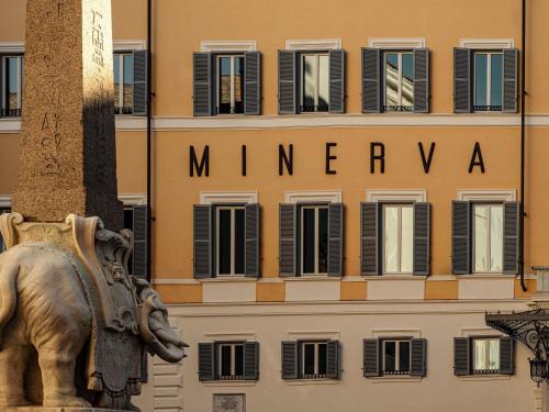 a statue of an elephant in front of a building at Orient Express La Minerva in Rome