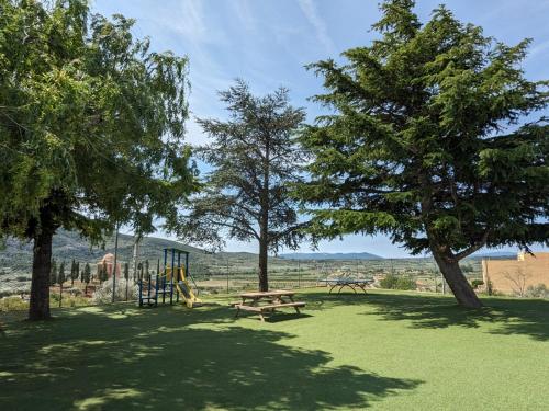 a park with a picnic table and a playground at Casa rural- Casa Liberta in Canet lo Roig