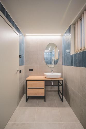 a bathroom with a sink and a mirror at Eos Lake House Luxury in Limone sul Garda