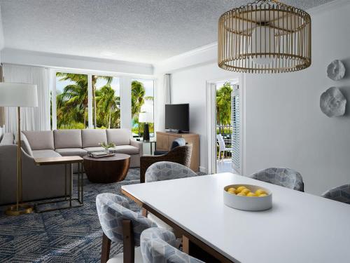 a living room with a table and chairs at Ocean Pointe Resort One-Bedroom Villa in Palm Beach Shores