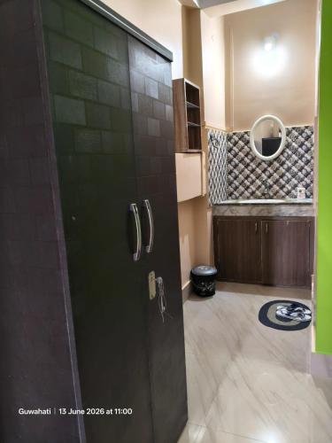 a door in a room with a kitchen at Prashaanti in Guwahati