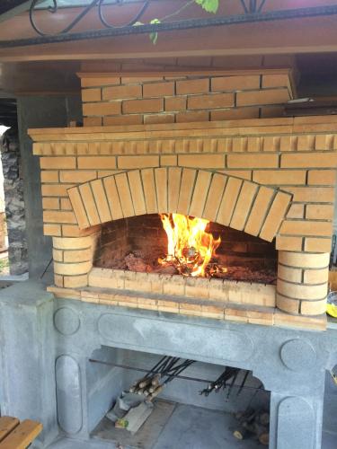 a brick oven with a fire in it at Guest house Hasmik in Yeghegnadzor