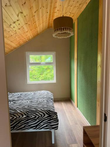 a room with a bed in a room with a window at The Barn in Cholpon-Ata