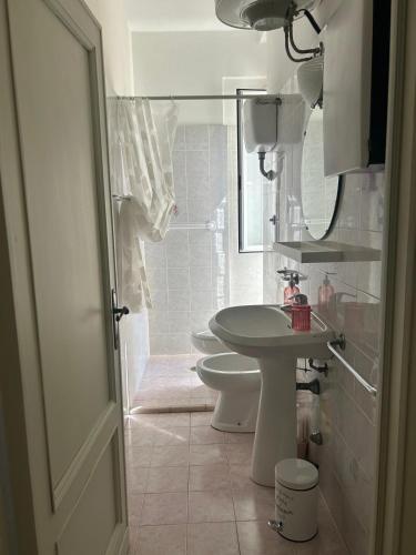 a bathroom with a sink and a toilet and a mirror at MareMare Follonica in Follonica