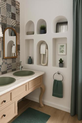 a bathroom with a sink and a mirror at Dar 'Villa Blanche' in Djerba