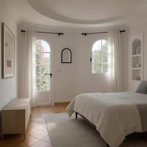 a white bedroom with a bed and two windows at Dar 'Villa Blanche' in Djerba