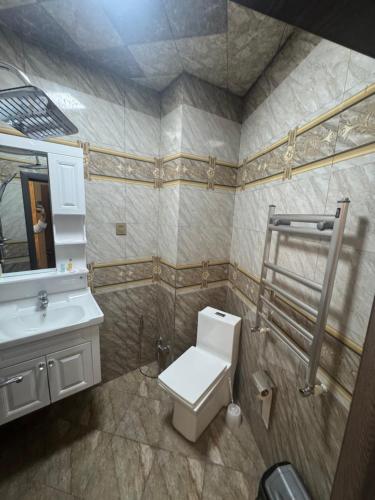 a bathroom with a toilet and a sink at Mountain-city in Zaqatala