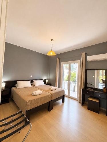 a bedroom with a bed and a television in it at Alexandra Apartment in Ipsos