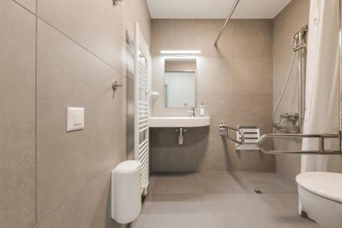 a bathroom with a sink and a toilet at Ostello Sport Center in Monte Ceneri