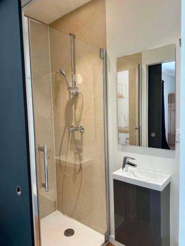 a bathroom with a shower and a sink at Lodges sous les oliviers in Propriano