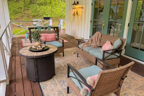 a porch with chairs and a table on a house at Dragonfly Cabin in Scaly Mountain