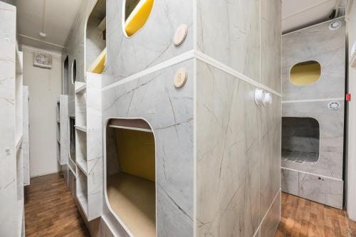 a room with a large marble wall with shelves at Arch Hostel in Almaty