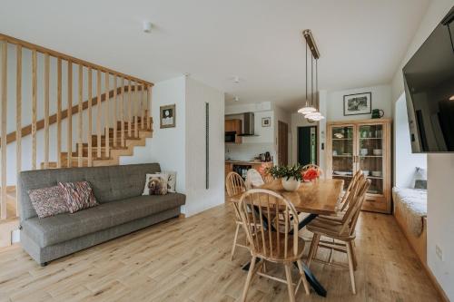 a living room with a table and a couch at Domki Tymianek & Melisa in Kościelisko