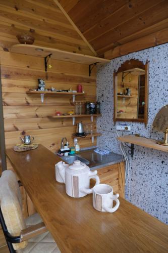 a kitchen with a wooden table with mugs on it at Riverside Apartment in Nikšić