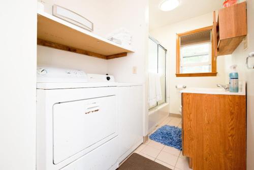 a kitchen with a white dishwasher and a sink at Beach House with Spacious Deck for Entertaining in Narragansett
