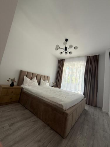 a bedroom with a large bed and a window at Urban Elegance in Cluj-Napoca