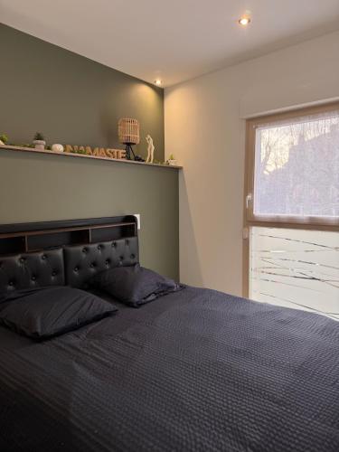 a bedroom with a large bed and a window at 101 - Centre de voiron in Voiron