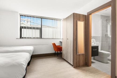 a hotel room with a bed and a bathroom at Clanbrassil Townhouse in Dundalk