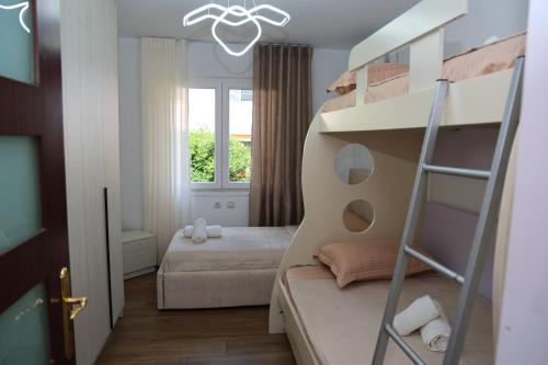 a small bedroom with a bunk bed and a ladder at Joni s Guest House in Krujë