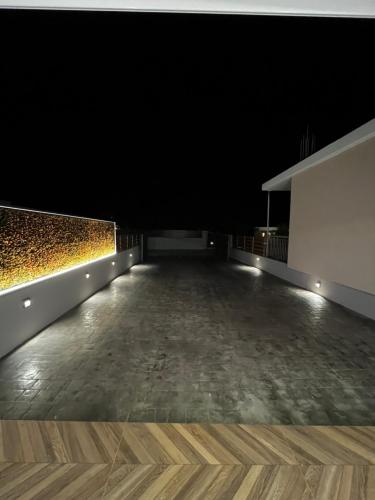 a dark room with a wooden floor and lights at Thomas Luxury home in Plisioí