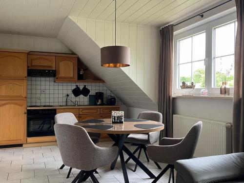 a kitchen with a table and chairs and a staircase at Große Auszeit in Gammendorf
