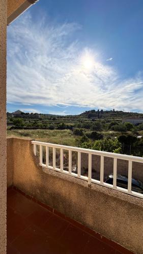 a balcony with a fence and a view of a field at Casa Rural Tío Cuchi in Bolbaite