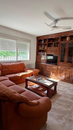 a living room with a couch and a coffee table at Casa Rural Tío Cuchi in Bolbaite