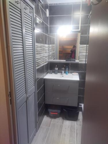 a bathroom with a sink and a mirror at Appartement en residence in Les Angles