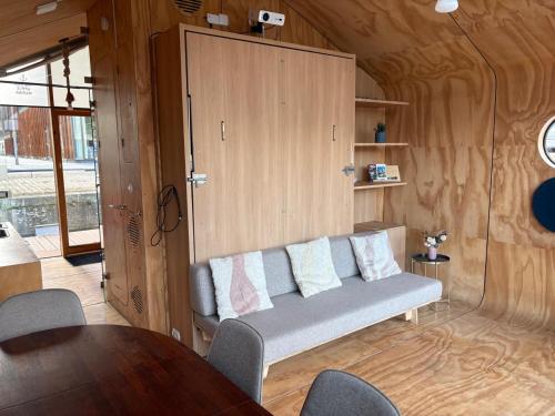 a living room with a couch and a table at Wikkelboats at Wijnhaven in Rotterdam
